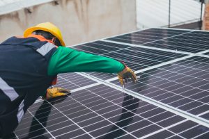 Construction worker fitting solar panels